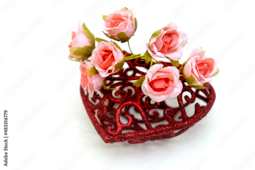 Artificial flower and red heart on white background, wedding interior detail close up Artificial flower and red heart on white background, wedding interior detail close up