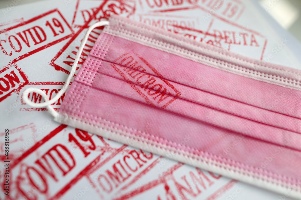 Obraz premium Pink medical mask with omicron print closeup