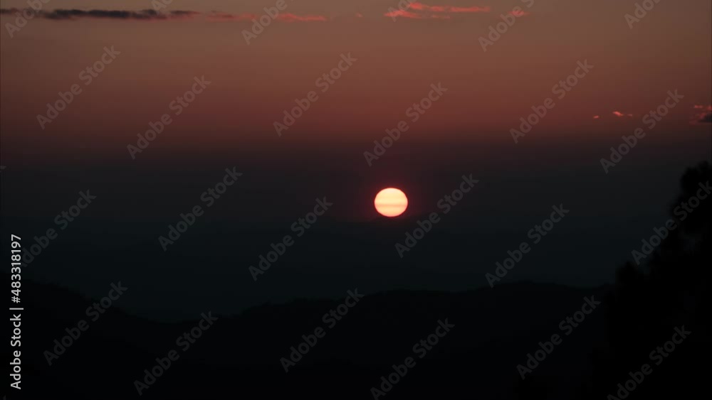 The setting sun in the evening when the sky is purple in the magic hour. on the mountain and fog view timelapse 4k