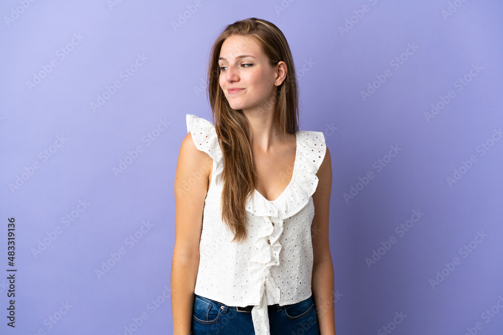 Young caucasian woman over isolated background having doubts while looking side Young caucasian woman over isolated background having doubts while looking side