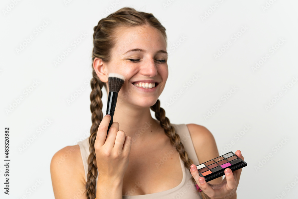 Young caucasian woman isolated on white background with makeup palette and happy Young caucasian woman isolated on white background with makeup palette and happy