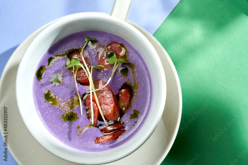 Cream soup of cabbage with smoked sausages in a plate with bright backgrounds. Selective focus, hard light Cream soup of cabbage with smoked sausages in a plate with bright backgrounds. Selective focus, hard light