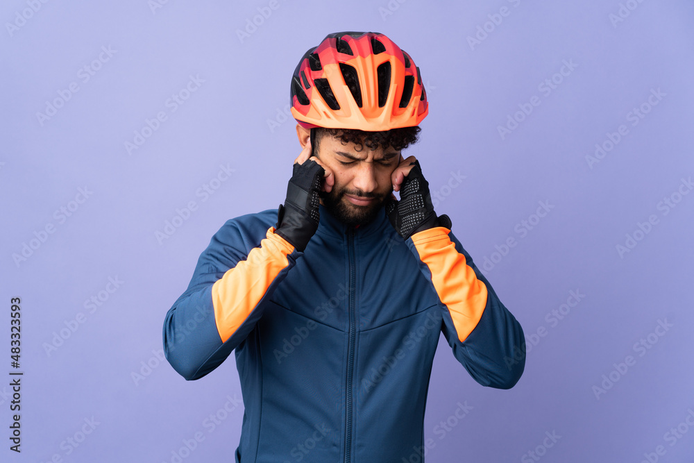 Young Moroccan cyclist man isolated on purple background frustrated and covering ears Young Moroccan cyclist man isolated on purple background frustrated and covering ears