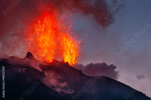 Active volcano eruption at night on Stromboli island in Italy
