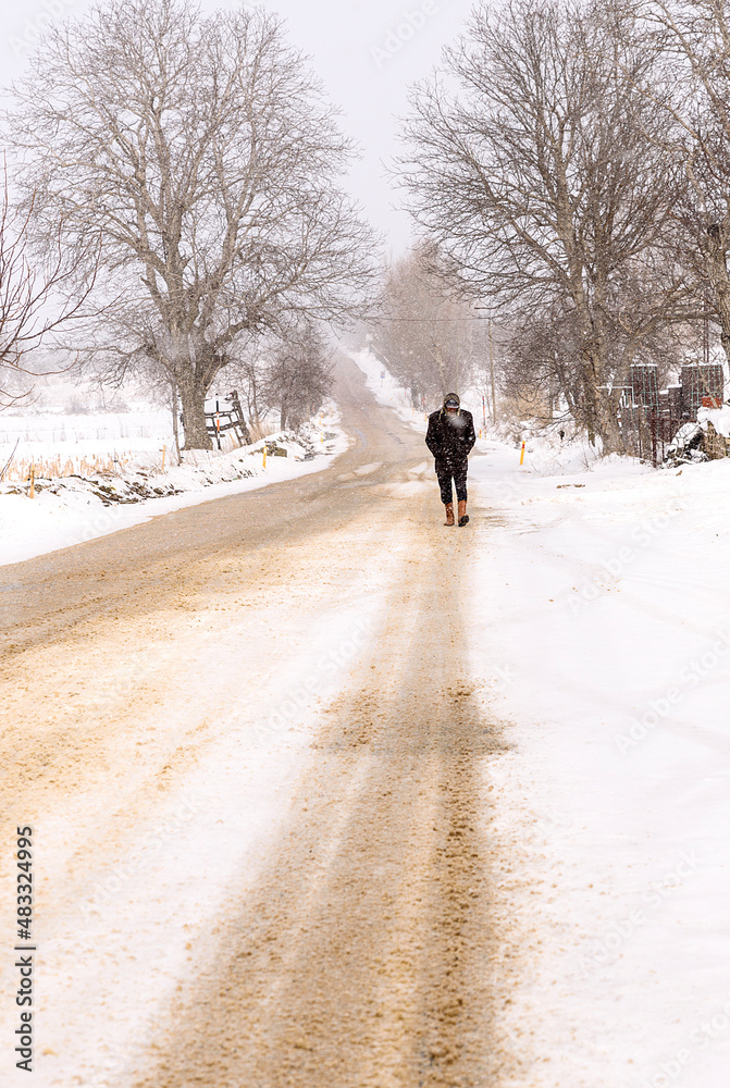 man walking cold in snow man walking cold in snow