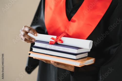 Closeup portrait of happy female student with certificate in college campus