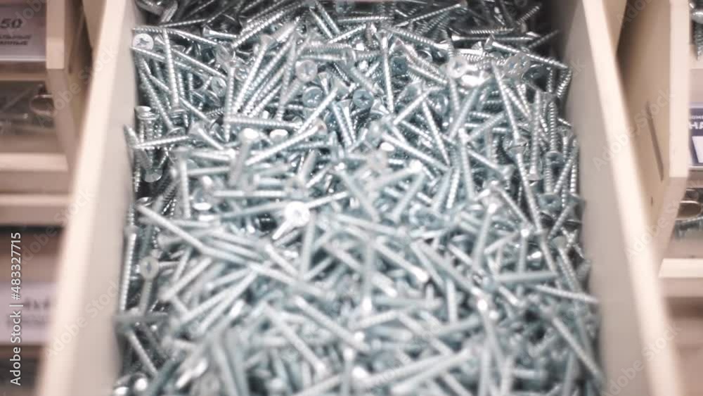 a box with silver self-tapping screws in floating focus