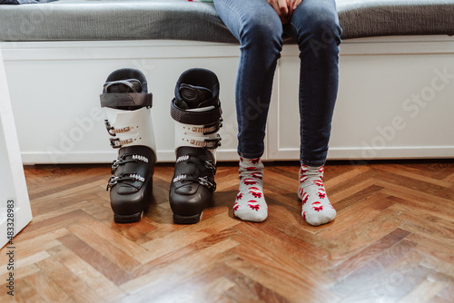 woman feet next to her are ski boots photo