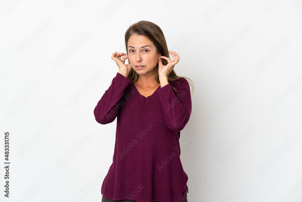 Middle age Brazilian woman isolated on white background frustrated and covering ears Middle age Brazilian woman isolated on white background frustrated and covering ears