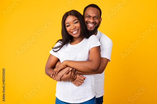 African American bearded man cuddling with his woman
