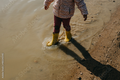 Child with yellow rubber boots
