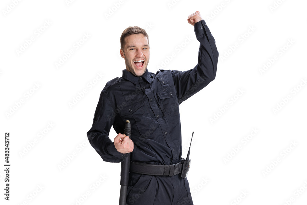 Studio shot young happy man, policeman officer wearing black uniform posing isolated on white background. Concept of job, caree, law and order. Studio shot young happy man, policeman officer wearing black uniform posing isolated on white background. Concept of job, caree, law and order.