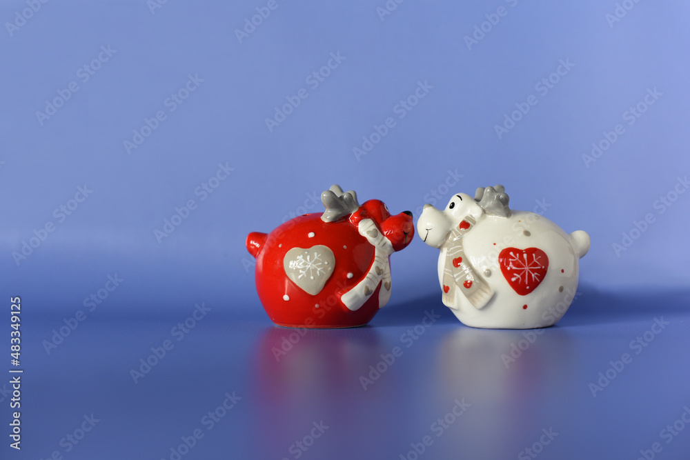 Valentine's Day congratulation card. Two funny figures of red and white deers in love on a blue background. Text space. Valentine's Day congratulation card. Two funny figures of red and white deers in love on a blue background. Text space.