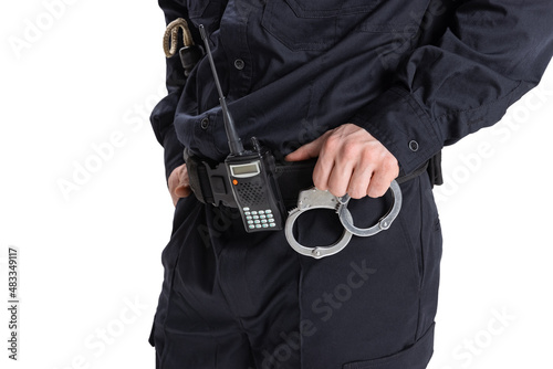 Cropped image of male policeman officer wearing black uniform with walkie-talkie and handcuffs isolated on white background. photo