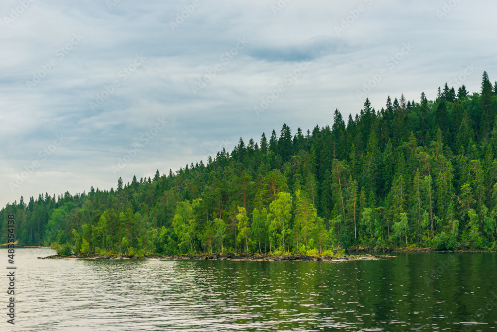 Fototapeta premium North Karelia lake, Russian wild nature. Forest growing on the stones
