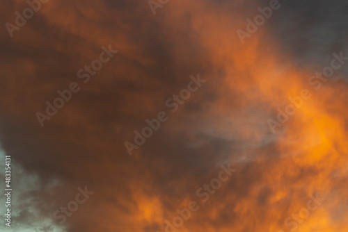 Fiery clouds. Sunset light. Orange sky. Landscape sunset colors.