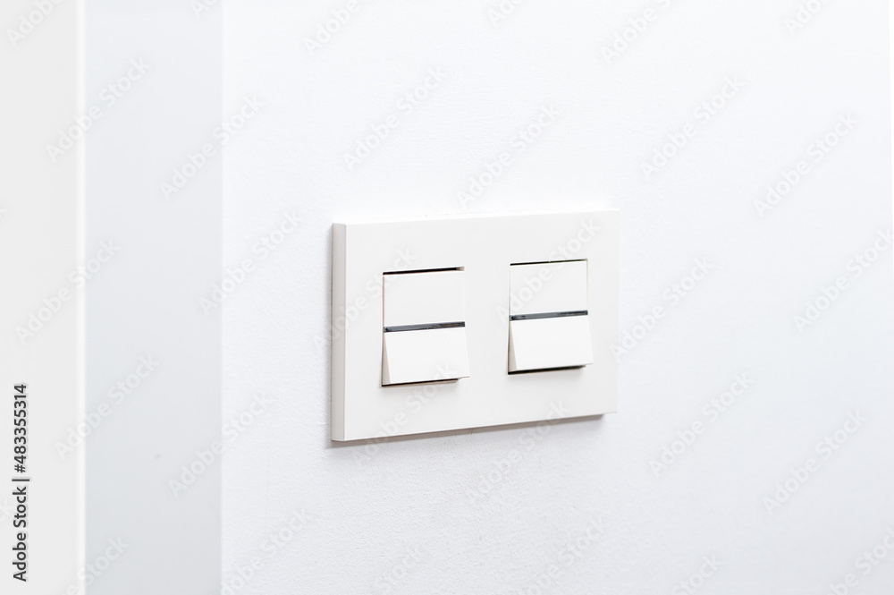 White light switch and faceplate on white wall White light switch and faceplate on white wall