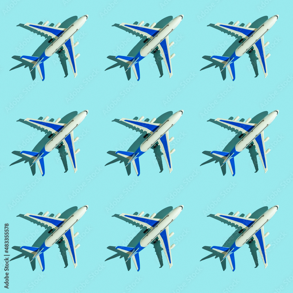 Seamless pattern with decorative passenger plane on blue background.