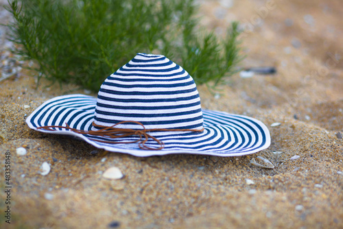 Striped beach hat on the sand