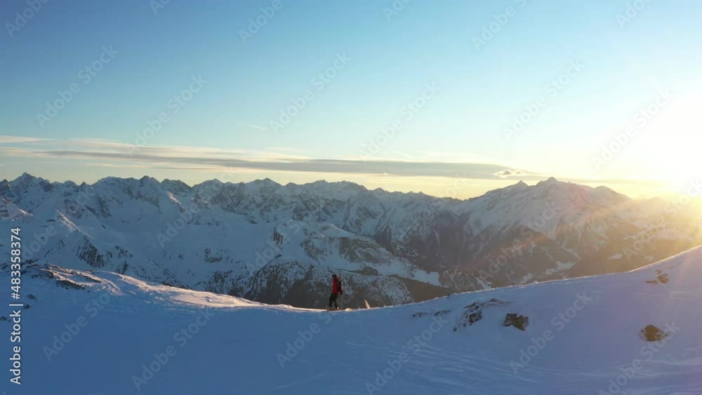 Young man climbing on ski in Alps. Aerial footage of winter activity. Alpin hiking, beautiful snowy mountain peaks. Young man climbing on ski in Alps. Aerial footage of winter activity. Alpin hiking, beautiful snowy mountain peaks.
