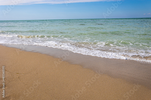 Beautiful bright colorful tropical summer background. Soft turquoise blue ocean wave on golden sandy beach.