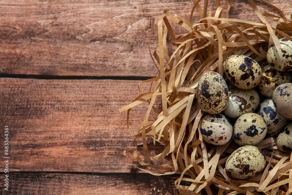 Small quail eggs on wooden background. Happy Easter background. Small quail eggs on wooden background. Happy Easter background.