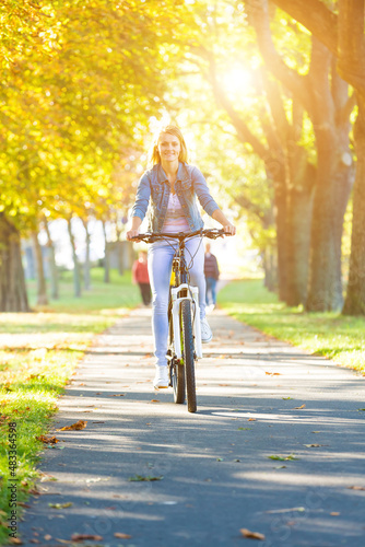 young woman on sports bike in autumn sunny city © luchschenF