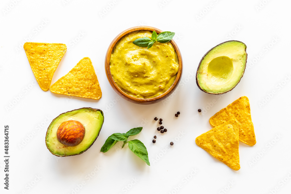 Avocado guacamole sause in bowl with nachos chips Avocado guacamole sause in bowl with nachos chips