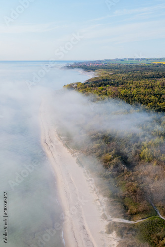 fog over the ocean hitting the shore in denmark