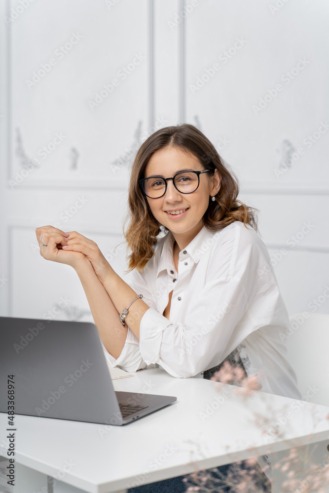 The girl at work looks at the camera The girl at work looks at the camera