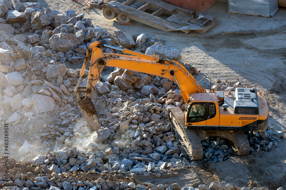 A hydraulic breaker is mounted on the excavator. It is powered by an auxiliary hydraulic system from the excavator, which is fitted with a foot-operated valve for this purpose. A hydraulic breaker is mounted on the excavator. It is powered by an auxiliary hydraulic system from the excavator, which is fitted with a foot-operated valve for this purpose.