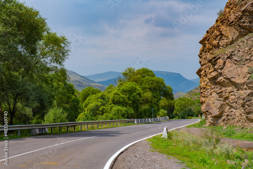 there is a wide road between the mountains © Vyacheslav