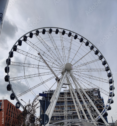 have fun with a beautiful ferris wheel. Grey sky full of clouds
