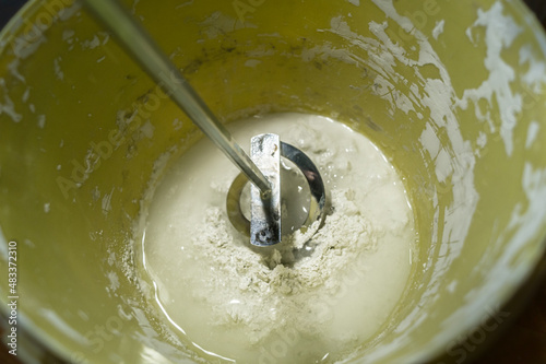 White putty in a bucket of water. Preparation of mortar for finishing walls and ceilings in the apartment. Repair in the house. DIY. Selective focus