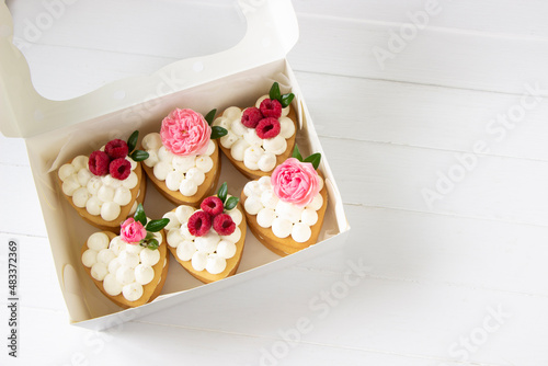 Heart shape honey cakes with fresh roses and raspberry. Valentine's day sweet box, sweet gift, sweets delivery, takeaway food box.White background