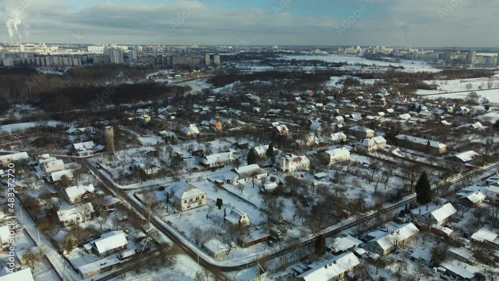 Low-rise urban development. The ground and buildings are covered with snow. Winter cityscape. Aerial photography. Low-rise urban development. The ground and buildings are covered with snow. Winter cityscape. Aerial photography.