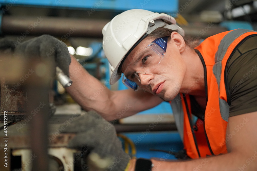 Industrial Engineers in Hard Hats.Work at the Heavy Industry Manufacturing Factory.industrial worker indoors in factory. man working in an industrial factory.