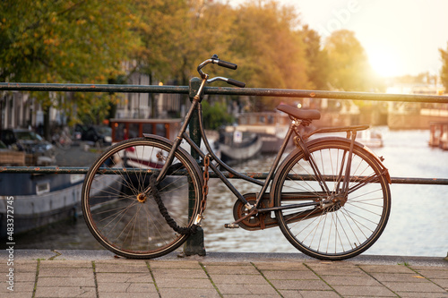 Bicycle On A Bridge In Amsterdam During Bright Sunset, Holland #483372745