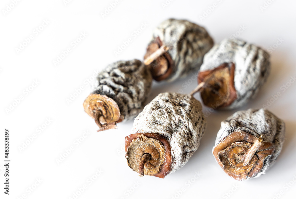 Dried, dried persimmon on a white background. Dried, dried persimmon on a white background.
