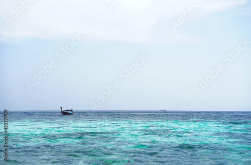 seascape scenery,blue sea water, local fishing boat © Verin
