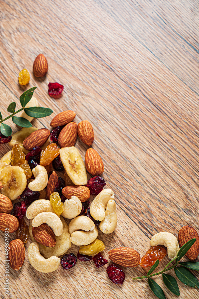 nuts and dried cranberry on the wooden background nuts and dried cranberry on the wooden background