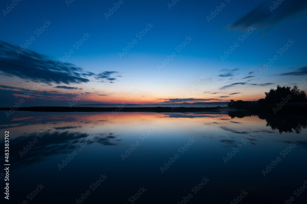 Fototapeta premium Sunset landscape with sky reflected in water