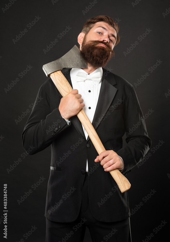 Bearded man scraping chin with axe dark background, barbering Bearded man scraping chin with axe dark background, barbering