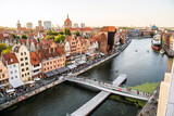 High Angle View Of Bridge Over River Amidst Buildings In City Of Gdansk In North Poland