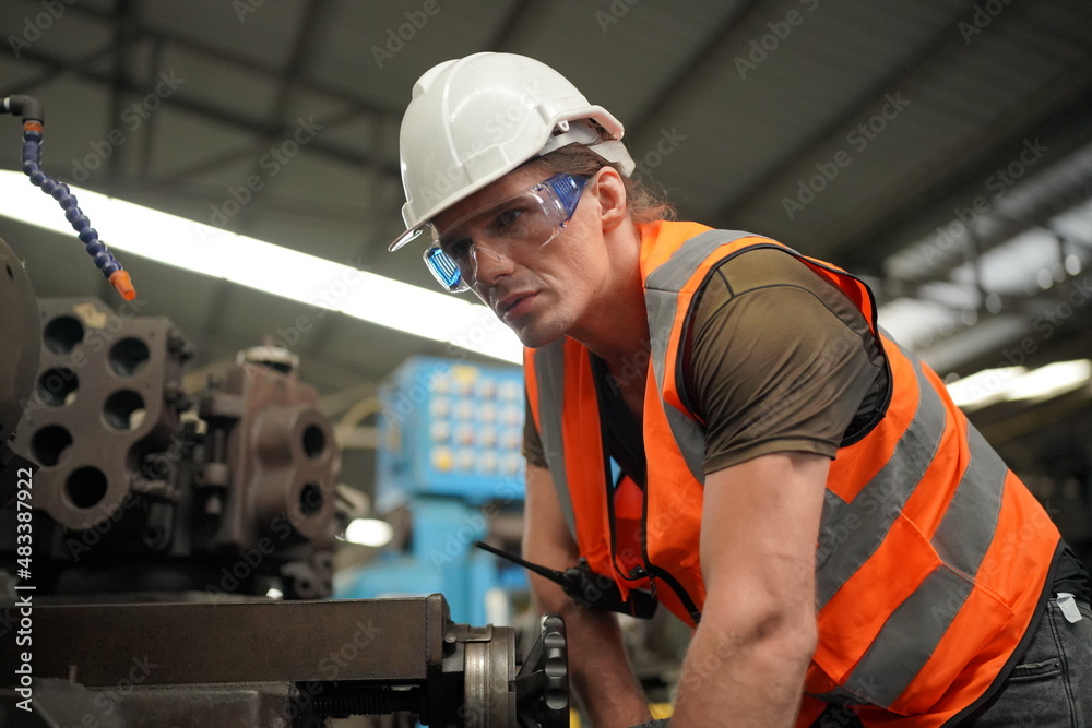Industrial Engineers in Hard Hats.Work at the Heavy Industry Manufacturing Factory.industrial worker indoors in factory. man working in an industrial factory. Industrial Engineers in Hard Hats.Work at the Heavy Industry Manufacturing Factory.industrial worker indoors in factory. man working in an industrial factory.