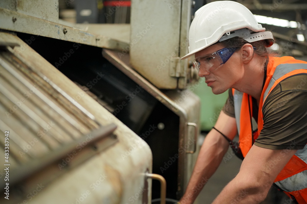 Industrial Engineers in Hard Hats.Work at the Heavy Industry Manufacturing Factory.industrial worker indoors in factory. man working in an industrial factory.