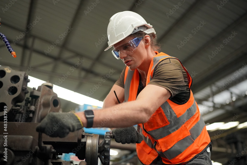 Industrial Engineers in Hard Hats.Work at the Heavy Industry Manufacturing Factory.industrial worker indoors in factory. man working in an industrial factory. Industrial Engineers in Hard Hats.Work at the Heavy Industry Manufacturing Factory.industrial worker indoors in factory. man working in an industrial factory.