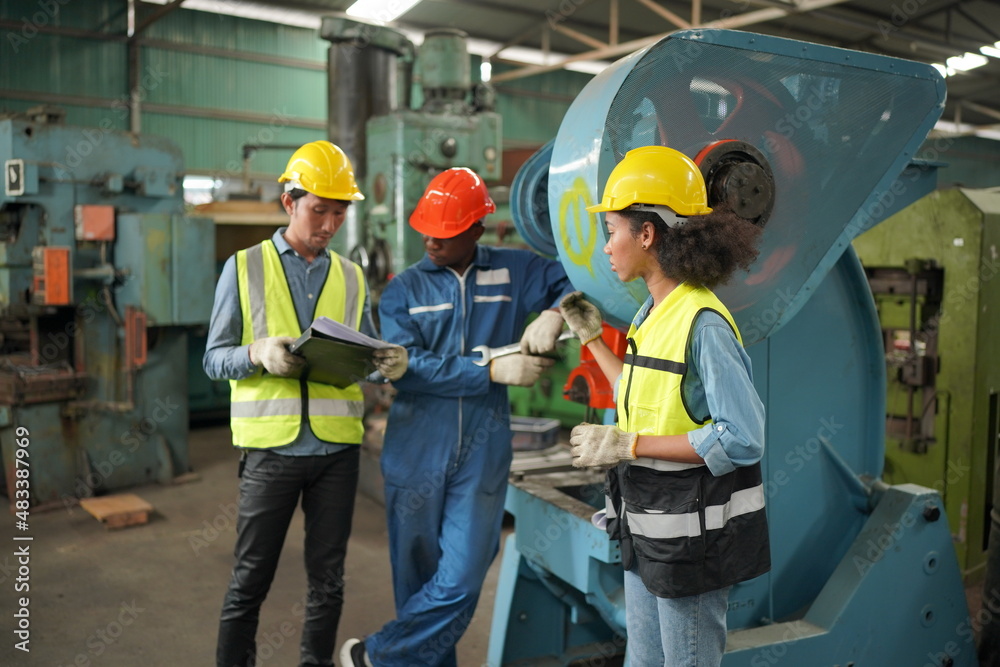 Industrial Engineers in Hard Hats.Work at the Heavy Industry Manufacturing Factory.industrial worker indoors in factory. man working in an industrial factory. Industrial Engineers in Hard Hats.Work at the Heavy Industry Manufacturing Factory.industrial worker indoors in factory. man working in an industrial factory.