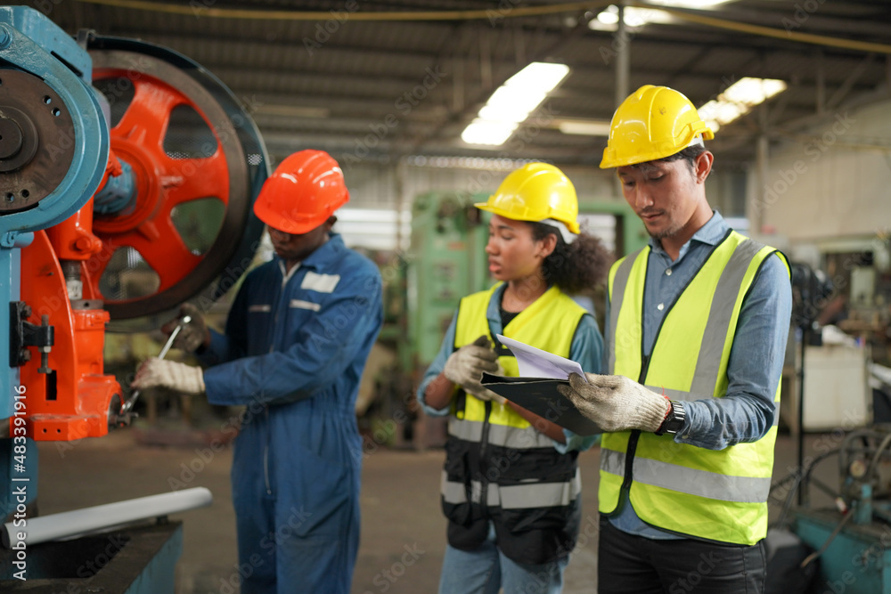 Industrial Engineers in Hard Hats.Work at the Heavy Industry Manufacturing Factory.industrial worker indoors in factory. man working in an industrial factory. Industrial Engineers in Hard Hats.Work at the Heavy Industry Manufacturing Factory.industrial worker indoors in factory. man working in an industrial factory.