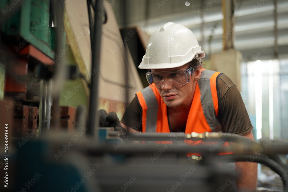 Industrial Engineers in Hard Hats.Work at the Heavy Industry Manufacturing Factory.industrial worker indoors in factory. man working in an industrial factory. Industrial Engineers in Hard Hats.Work at the Heavy Industry Manufacturing Factory.industrial worker indoors in factory. man working in an industrial factory.
